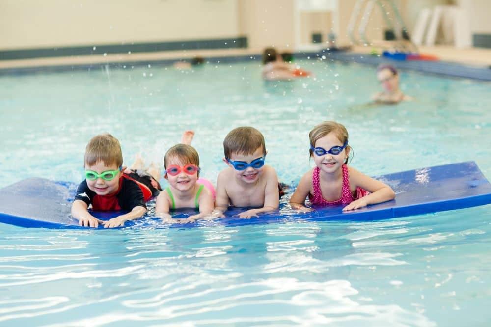Four children at floating device learning to swim at PRO Club
