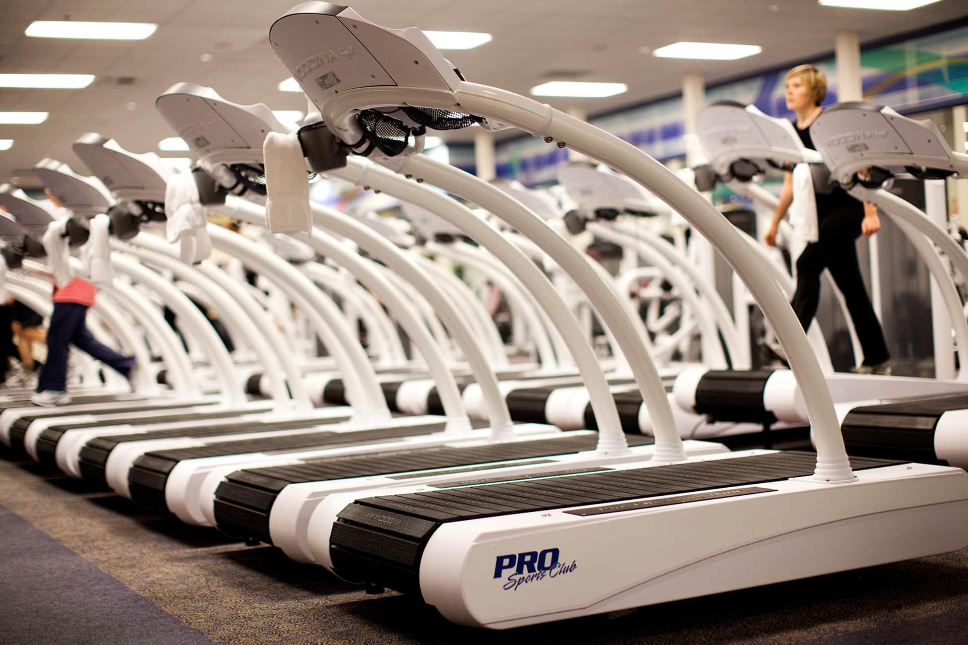 White PRO Club treadmills lined up in a row