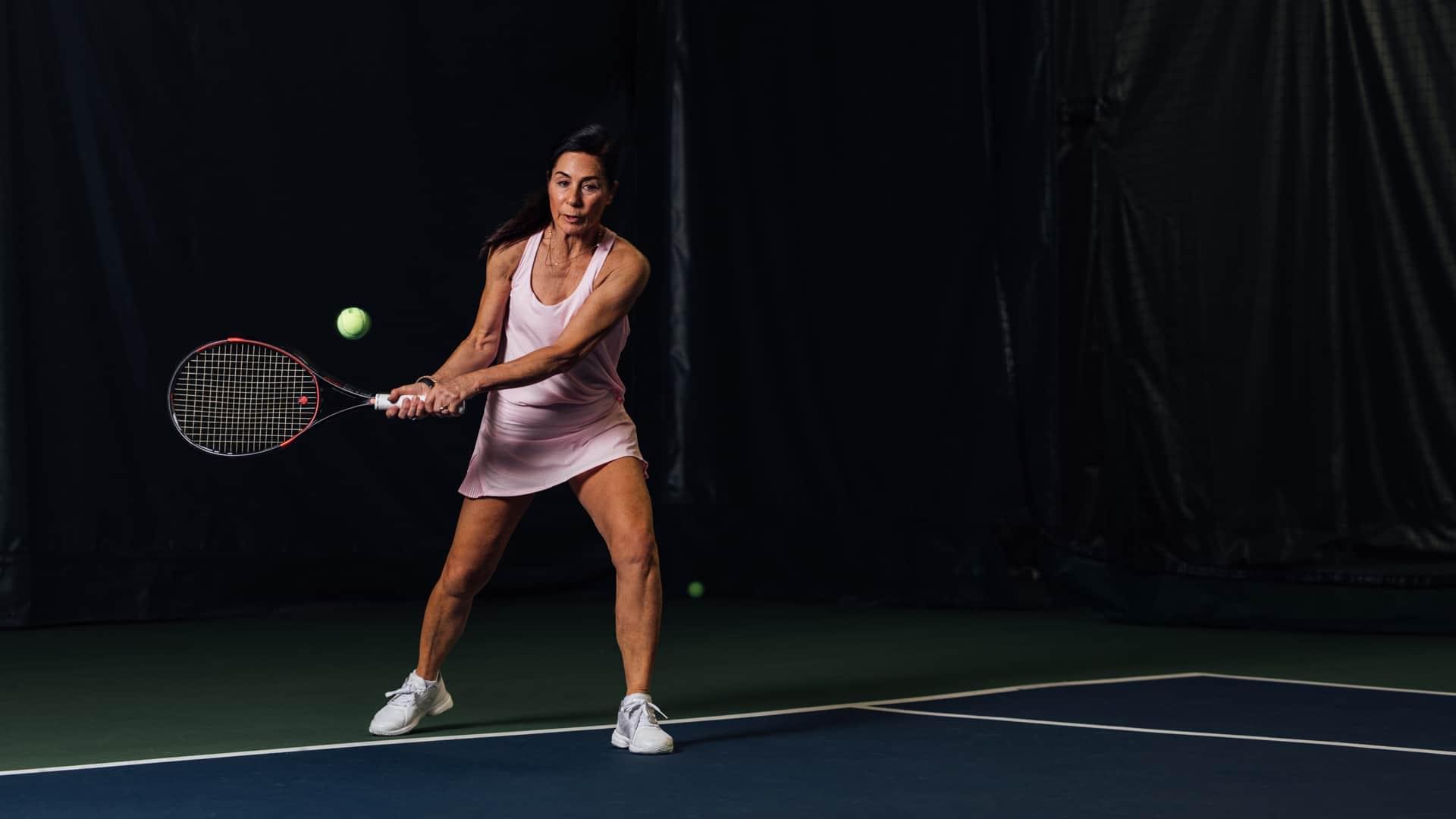 A PRO Club Tennis Member returning a serve at PRO Club - Bellevue