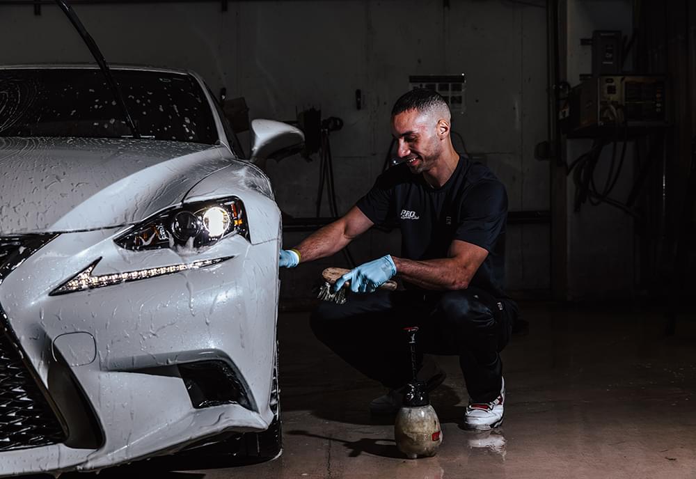 A Pro Club specialist working on a car at the Pro Club Auto Salon