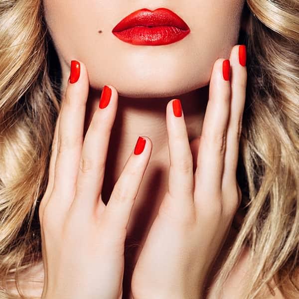 A blonde woman with red nails polish