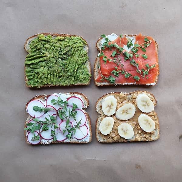 Four slices of bread with various ingredients