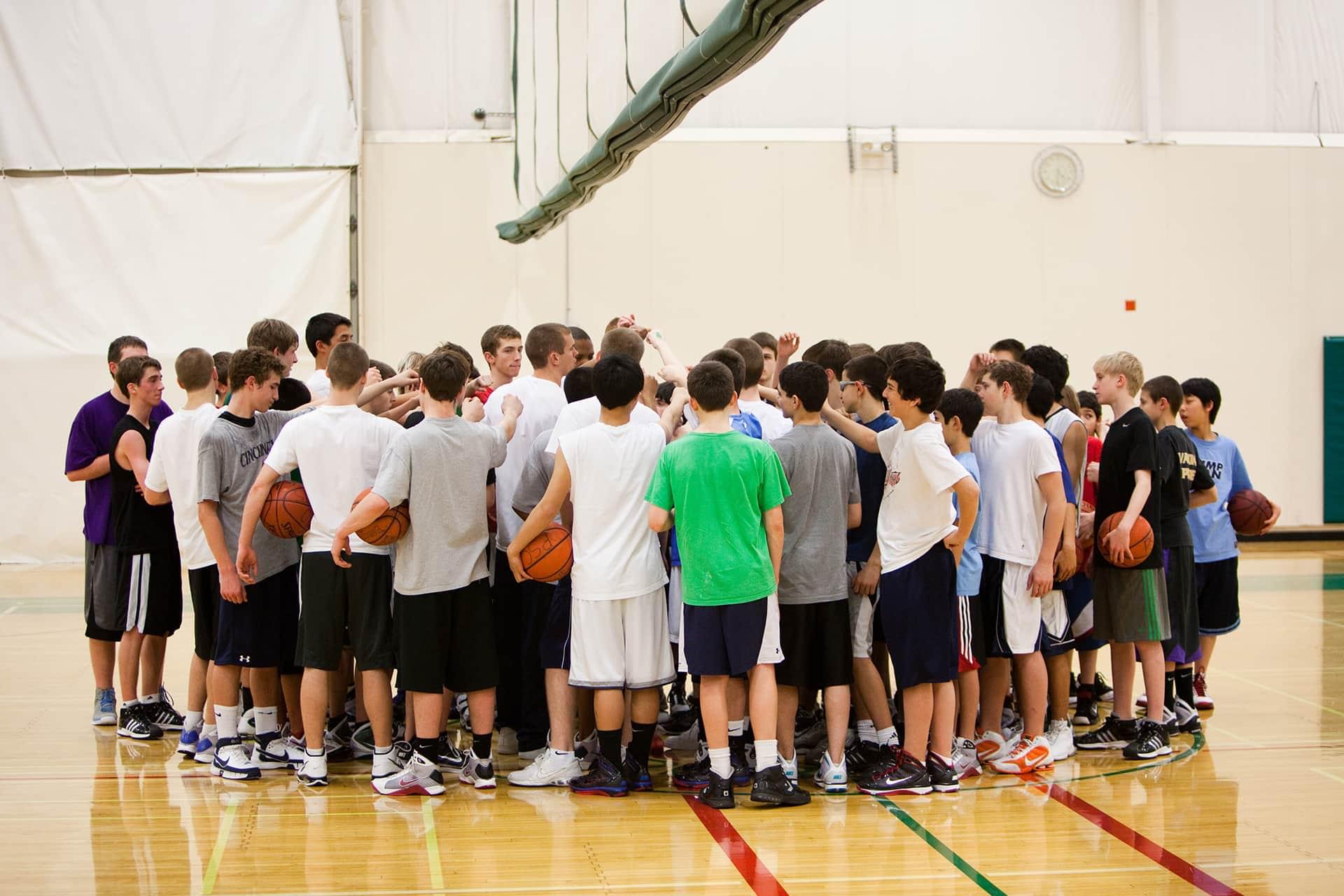 Group of young men getting ready to play basketball