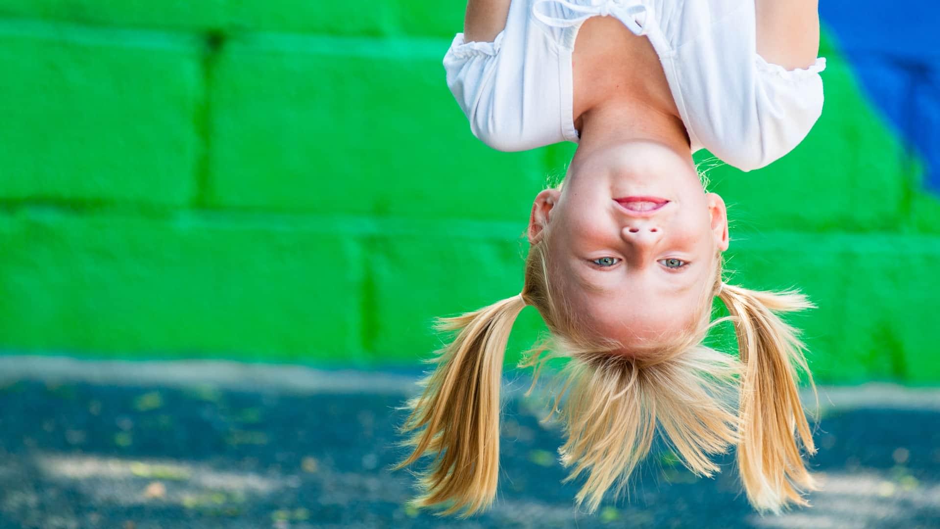 Blonde girl hanging upside down
