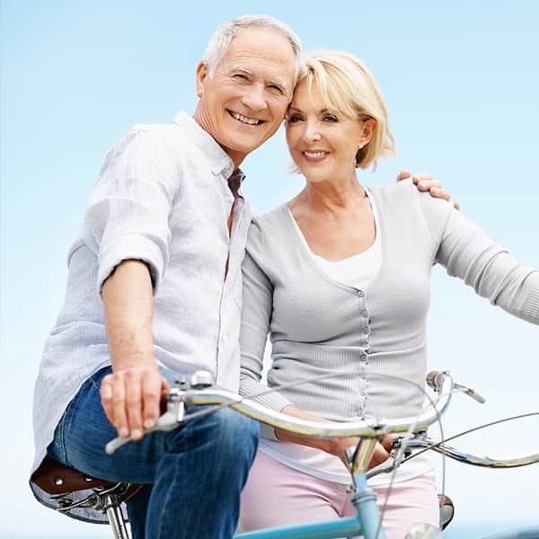 Mature couple riding bikes