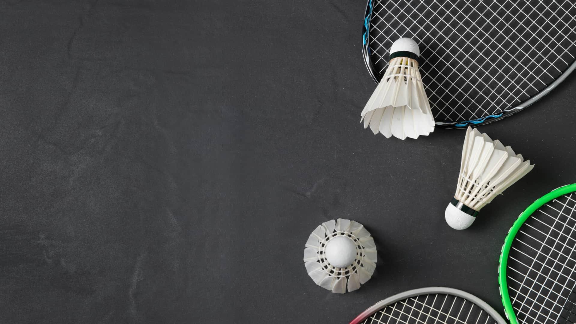 Three badminton birdies and rackets